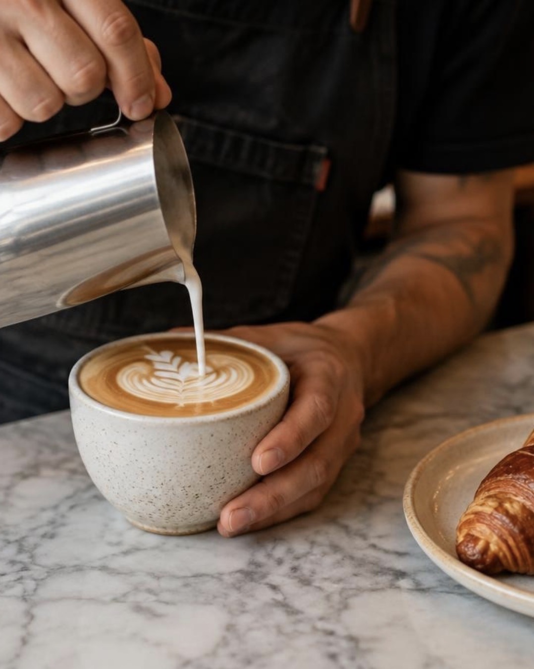 Barista pouring latte art